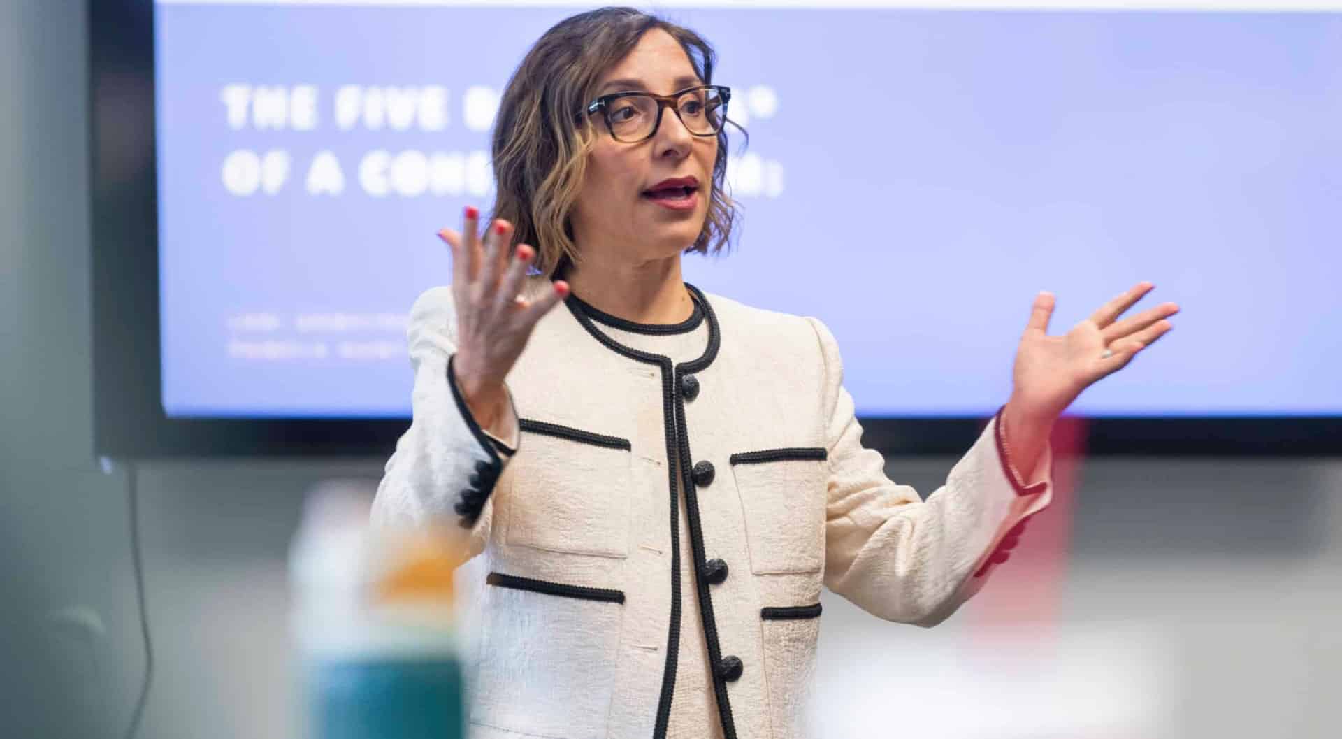 Keynote speaker gesturing during a presentation.