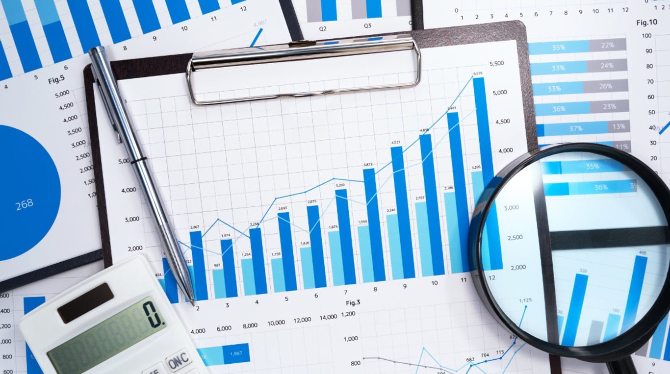 Financial data charts with pen, calculator, and magnifying glass. Leadership skill analysis.